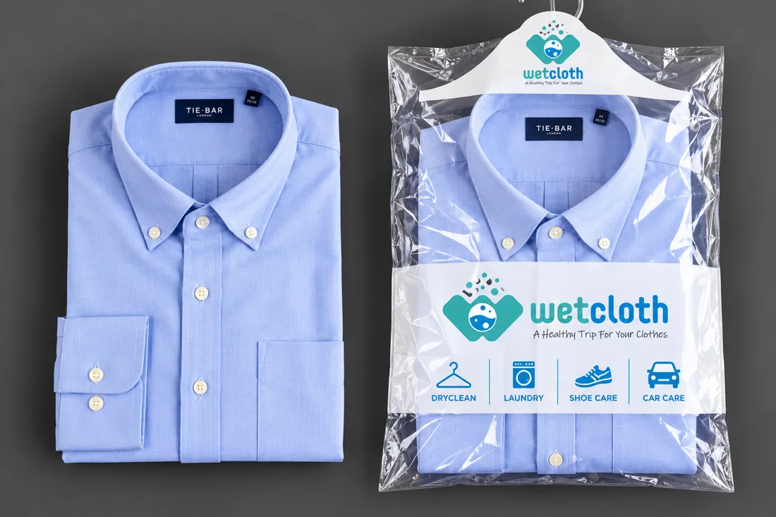 Folded dress shirt beside a shirt packed in Wet Cloth branded garment packaging